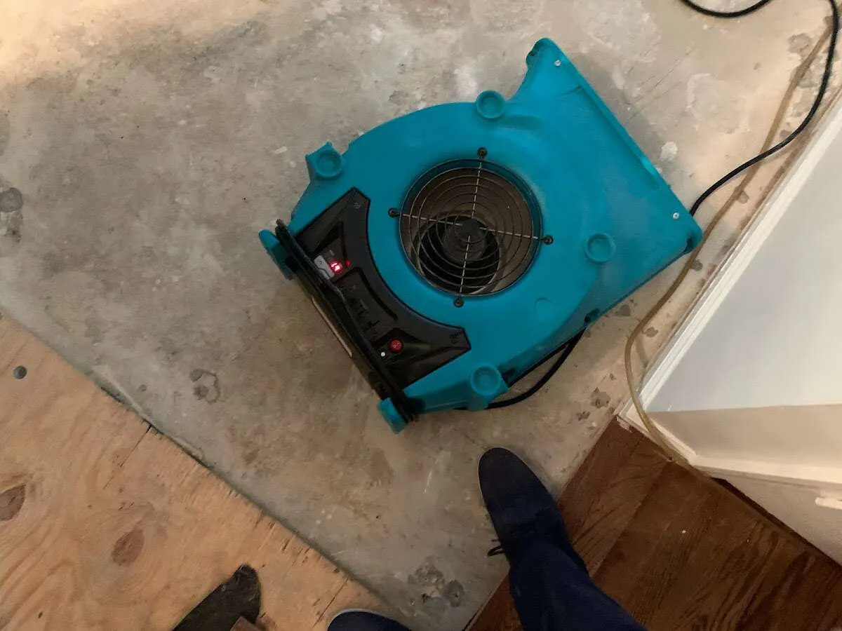 Air mover drying subfloor during Commercial Water Damage Restoration in Stevens Point
